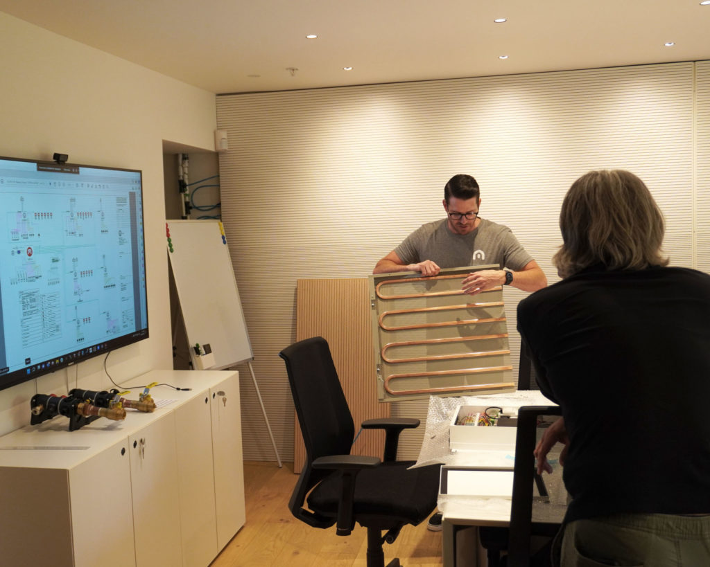 Bryan showing Liang Architecture Bureau+ our metal radiant ceiling panel for radiant cooling and heating.