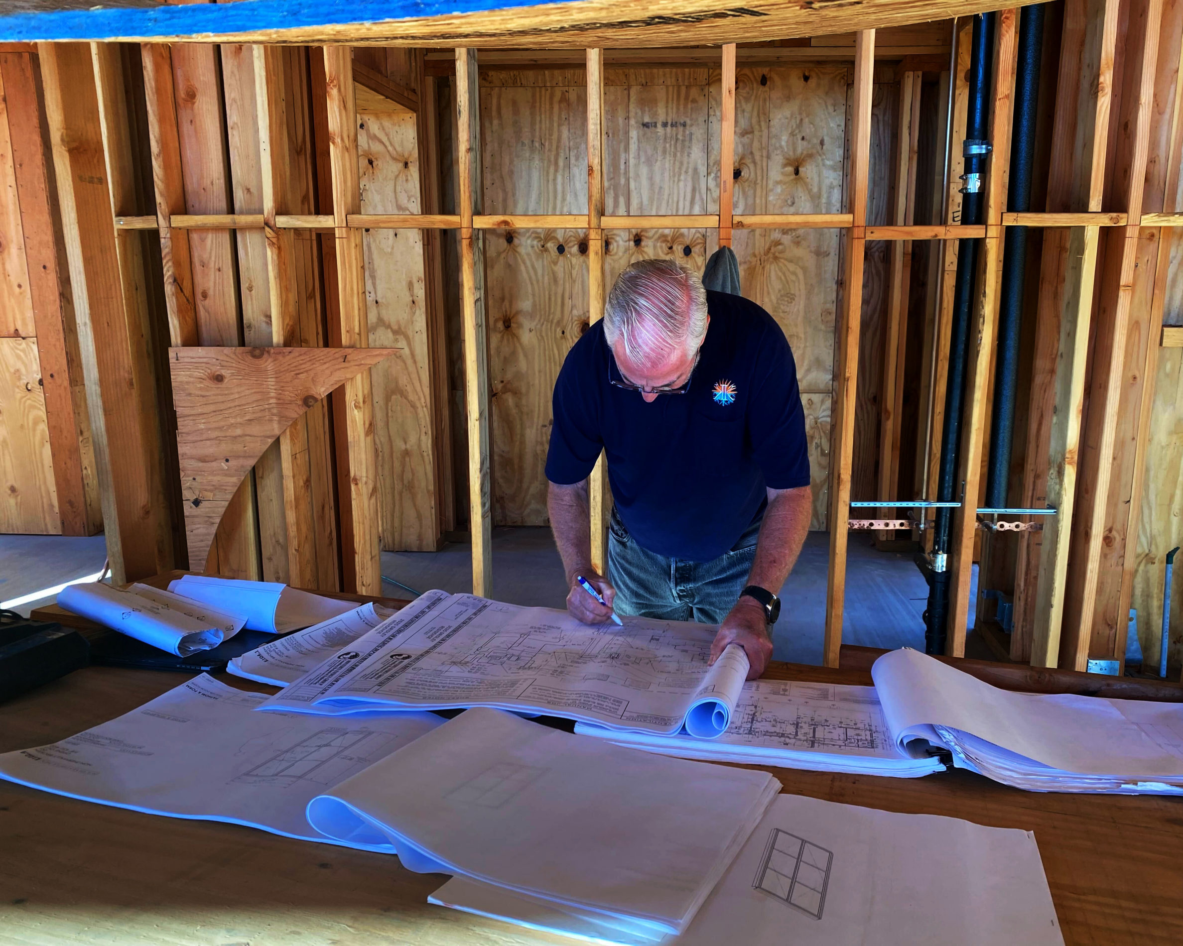 Ed Kline of Kline's Kustom Heating and Air reviewing hydronics plans.