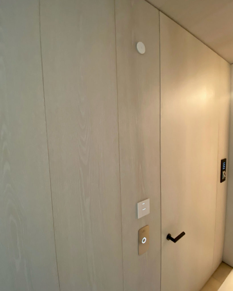 mSense room comfort sensor installed in a wood wall.