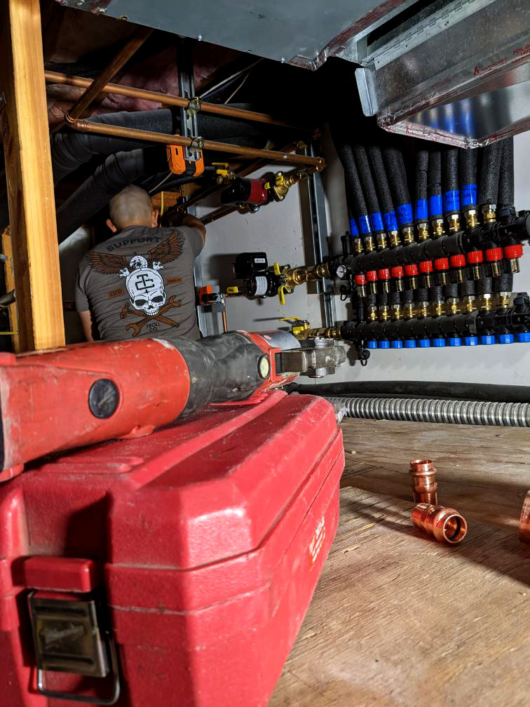 Wong 2 Mech Room Kline's Kustom Heating and Air working on a Messana Modular Manifold for a Radiant Ceiling/Floor and Fan Coil system.