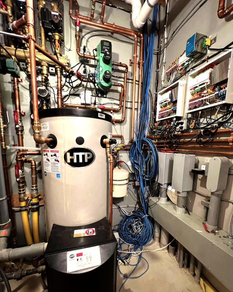 New Hampshire mechanical room that provides hot and cold water for hydronic heating and cooling.