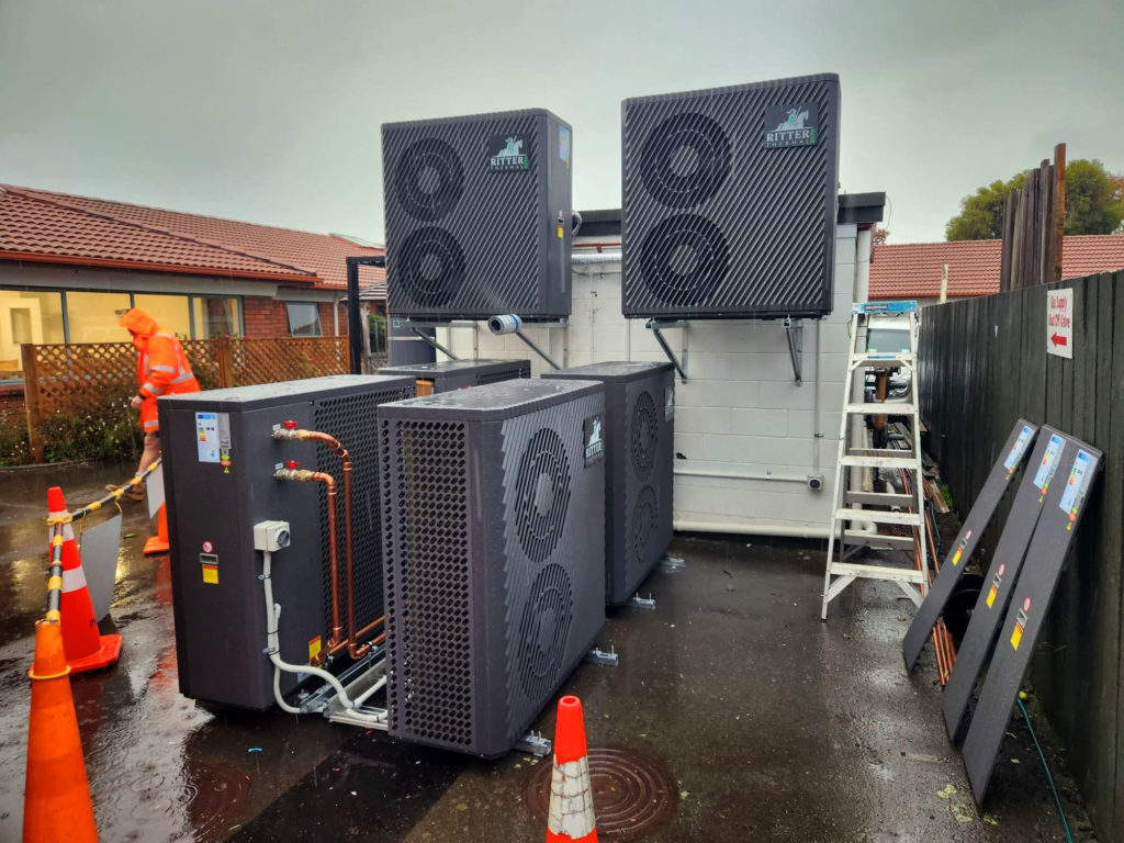 Two electric cascaded heat pump systems, one for DHW and the other for the building's hydronic heating/cooling system.