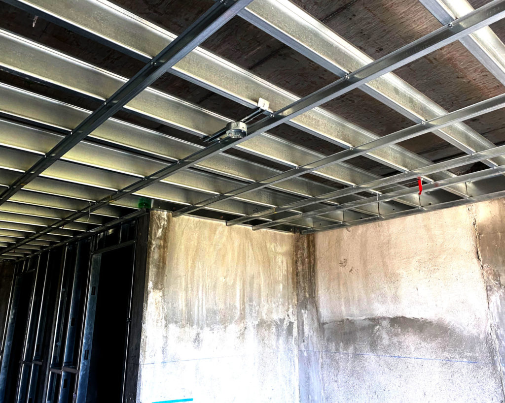 Metal hat channels spaced 24" O.C. for a radiant ceiling install.