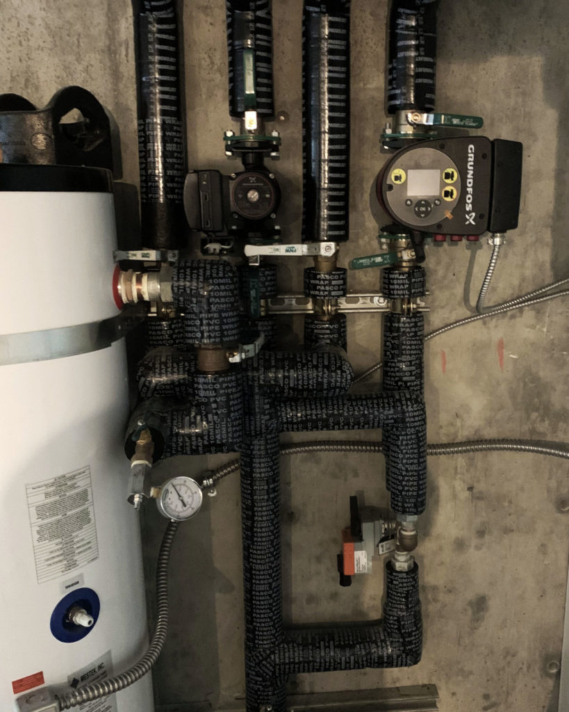 Mechanical room for a hydronic system that will provide radiant cooling and heating.
